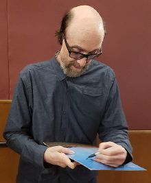 Winston autographing a copy of his album in 2019