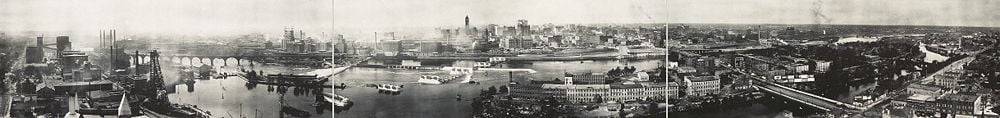 Mississippi riverfront and Saint Anthony Falls in 1915. At left, Pillsbury, power plants, and the Stone Arch Bridge. The tall building is Minneapolis City Hall. In the foreground to the right are Nicollet Island and the Hennepin Avenue Bridge.